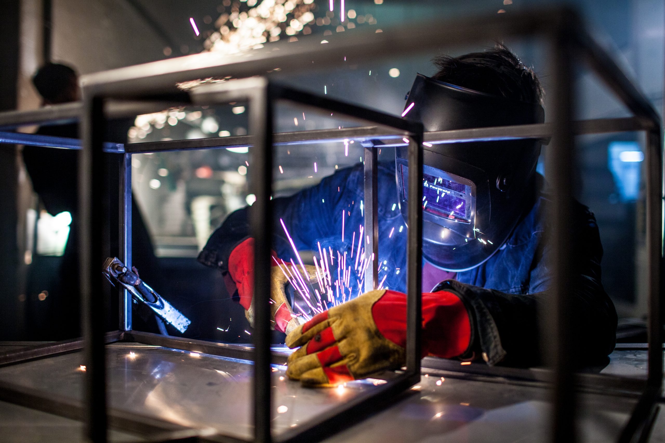 welderman-welds-protection-helmet-factory-welder-workplace-welding-metal
